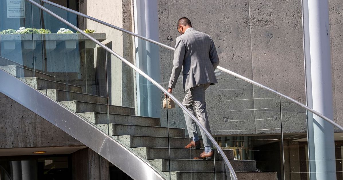 Man walking up stairs in business suit